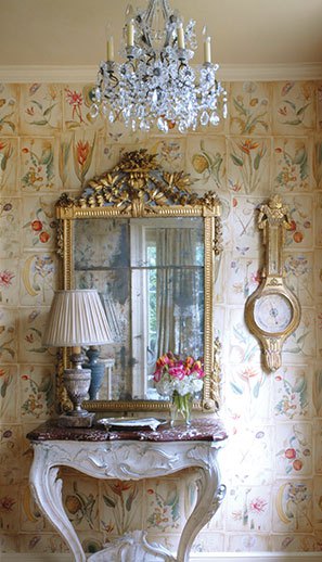 A Clarence House botanical wallpaper and antiques from Bremermann Designs welcome in this entry. | Photo by Kerri McCaffety
