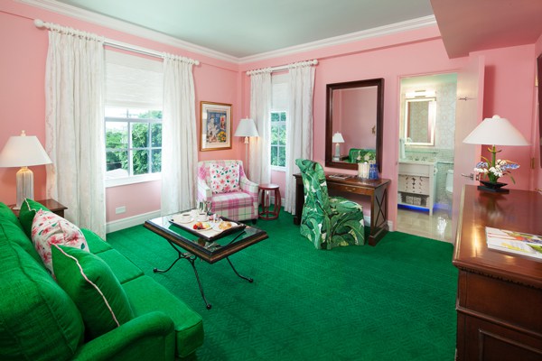 A guest room sitting area preppy in pink and green. Photo courtesy of Colony Hotel
