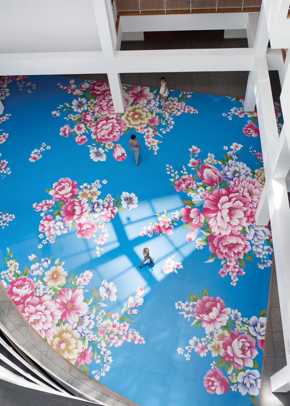 Overhead view of the floral floor painting by artist Michael Lin, titled Utah Sky 2065-40 (blue curve), at the High Museum of Art