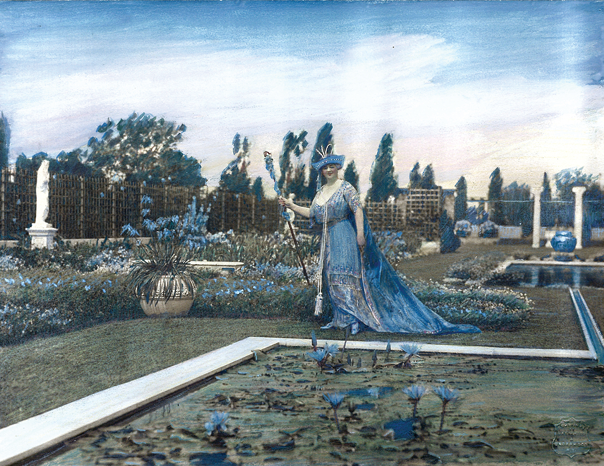 portrait of Harriet James in Newport's Blue Garden, wearing the dress she famously war at the garden's 1913 debut