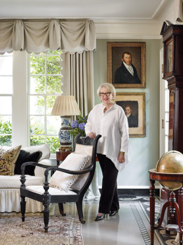 Jackye Lanham’s living room defines her calm, cool, and collected style with its mix of antiques, blue-and-white porcelains, stately portraits, and soft color palette.
