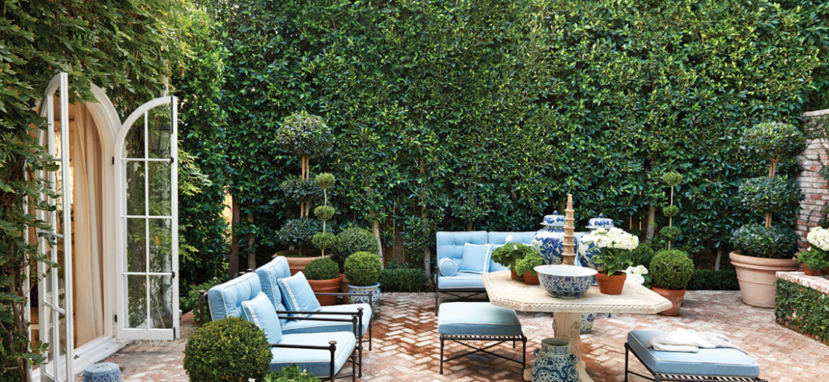 Designer Mark Sikes garden courtyard, surrounded in green living walls
