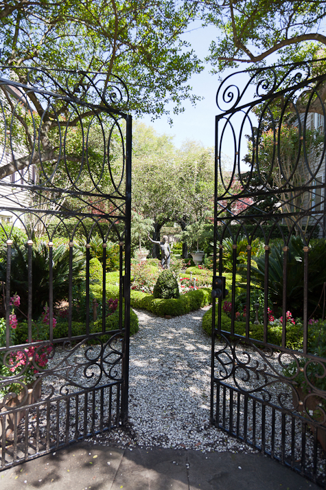 Garden gates open to parterres  with a sculpture from the late 1700s.