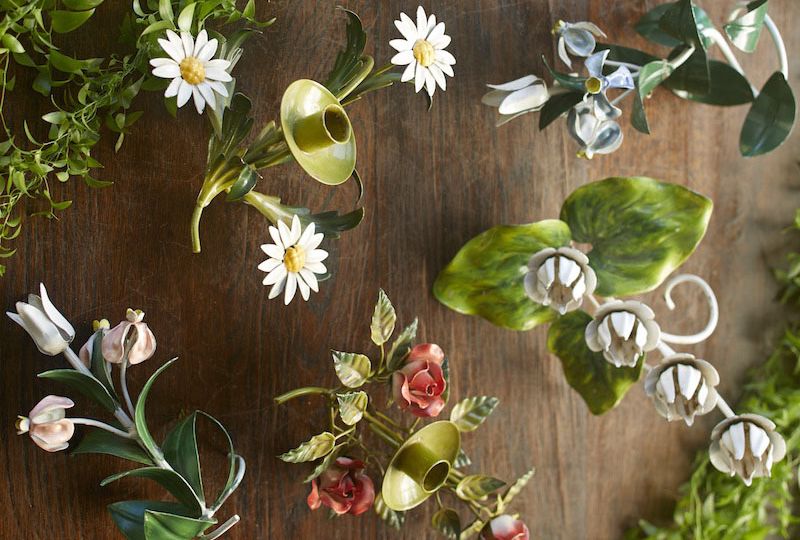 The liveliness of Italian tole is captured in these vintage candleholders with daisies, roses, and tulips, and leaves in varying shades of green.