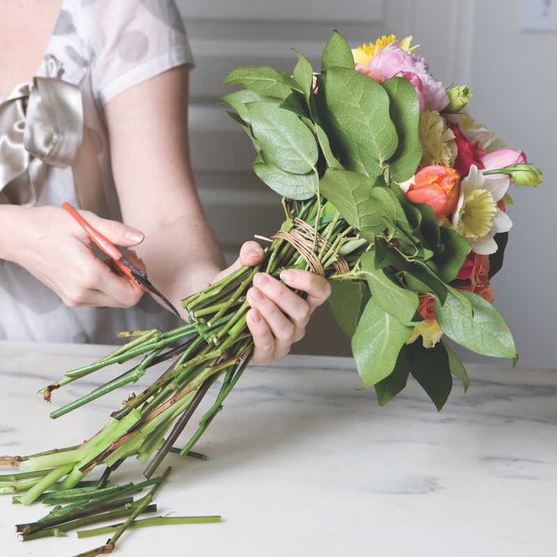 Mimi Brown cuts the stems at the bottom of the bouquet.