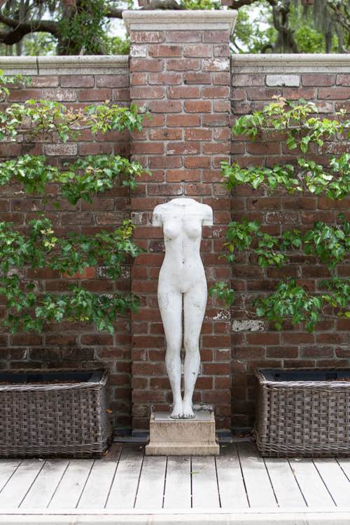 "Leitzl" sculpted by Dan Corbin, flanked by espaliered pears, stands in stark contrast to the garden wall.