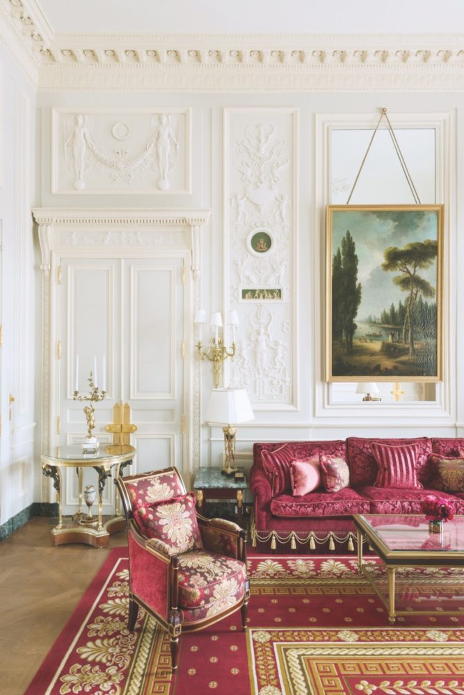 Ritz Paris suite with ornate walls and rich red upholstery with gold-toned details