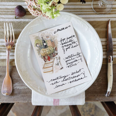 Place setting with summer menu on a plate