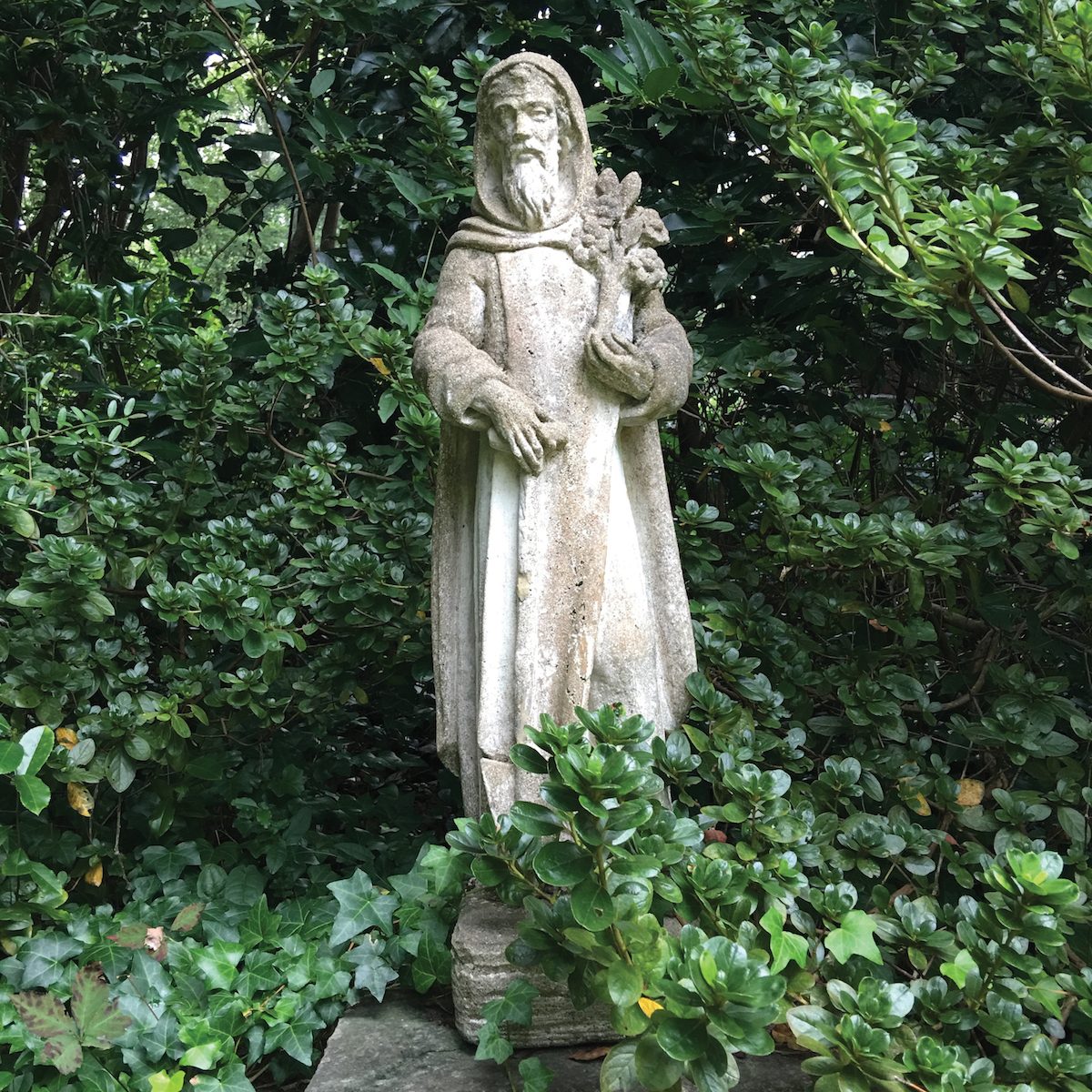 A statue of St. Fiacre, the patron saint of gardeners in Louise Wrinkle’s Mountain Brook, Alabama garden
