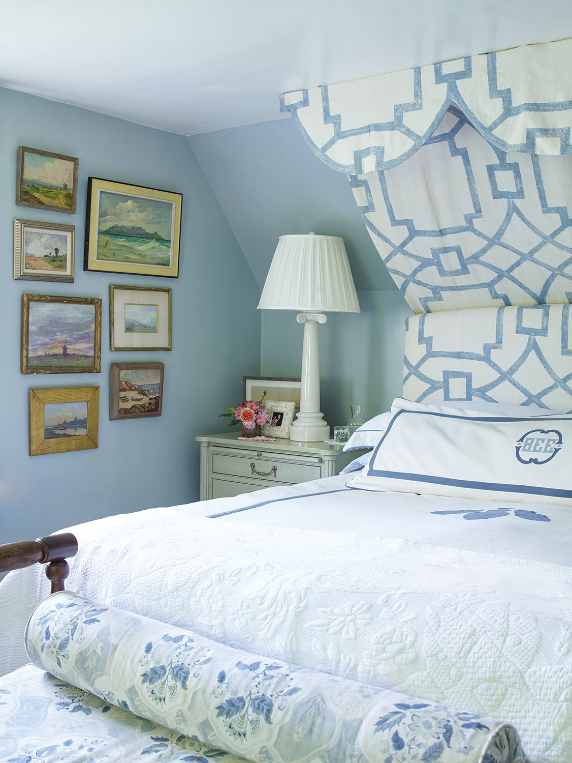 ky-blue walls and cloud-white bedding trimmed in blue. A half-canopy camouflages the sloped ceiling while creating height and adding drama to the master bedroom