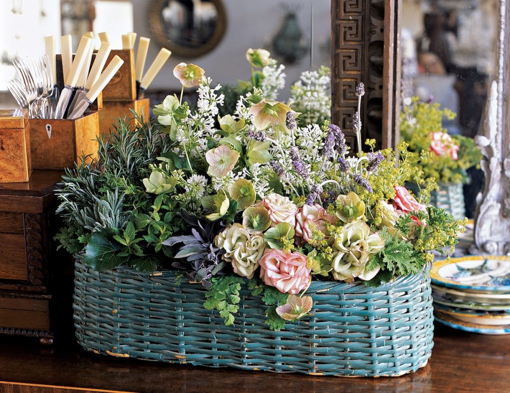 Rustic blue woven basket filled with flowers arranged by Sybil Sylvester of Wildflower Designs.