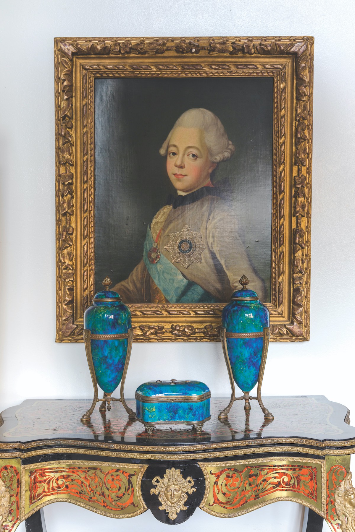 Portrait by Paul Milet over table with cobalt box and jars
