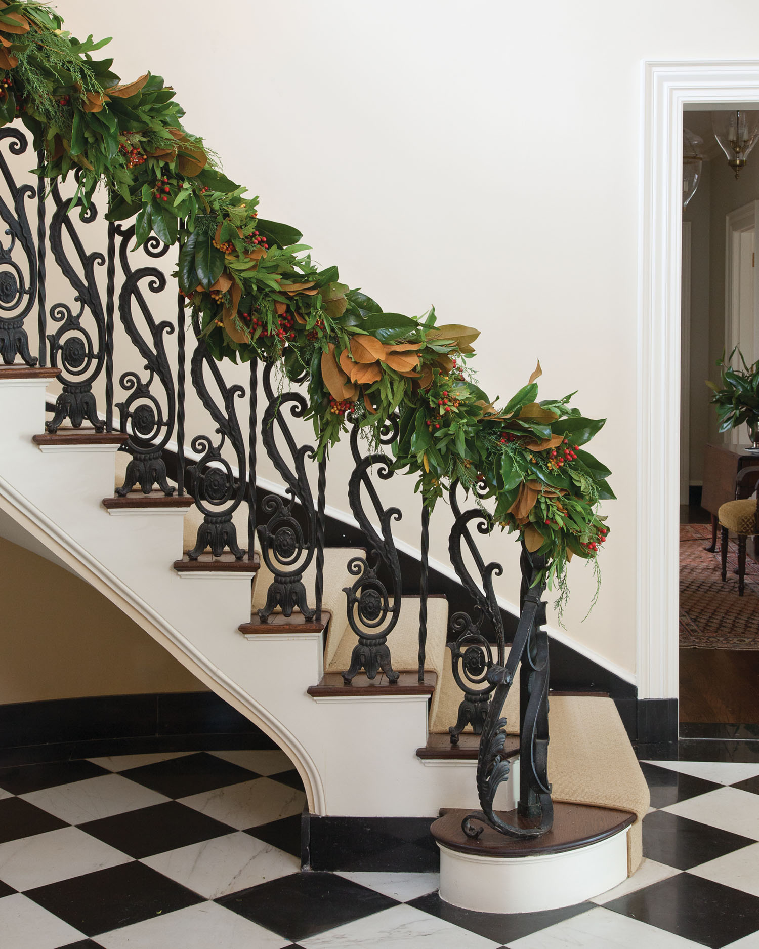 Jessica Sloane's finished evergreen garland on a wrought iron bannister
