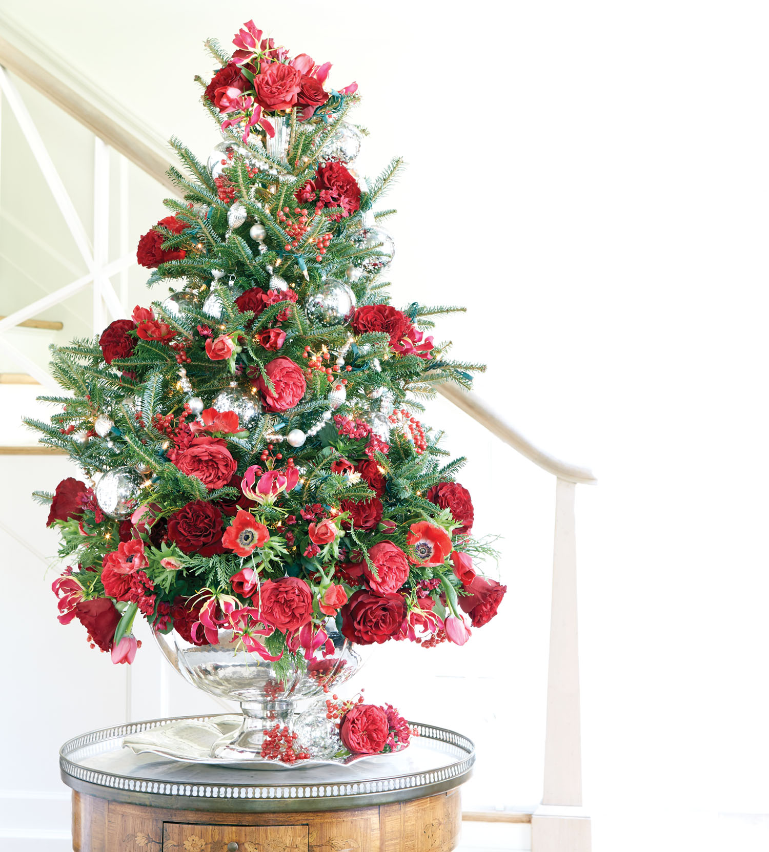 Ray Jordan's finished tabletop Christmas tree decorated with red flowers on an entry table