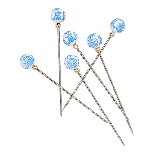 Six metal picks topped with a white bead with a blue chinoiserie pattern