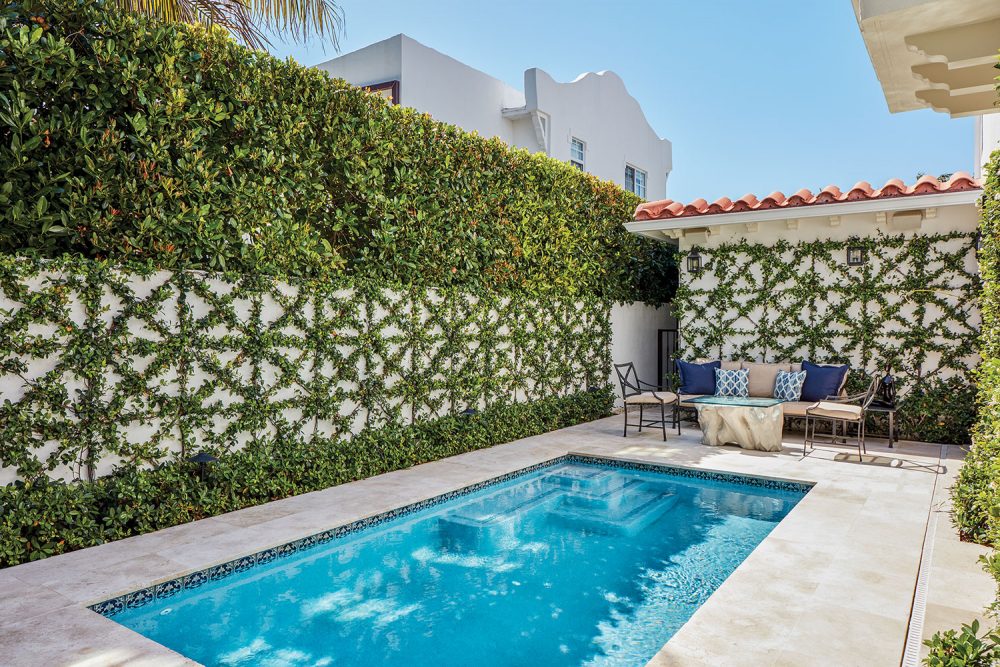 Photo of a courtyard pool. The trellis that garden designer Fernando Wong attached to the surrounding walls features a grid of squares crisscrossed by diagonal bars.