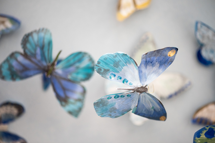 Detail photo of hand-painted butterflies installed in Grace's Green Garden Sunroom, featuring hues for blue and green