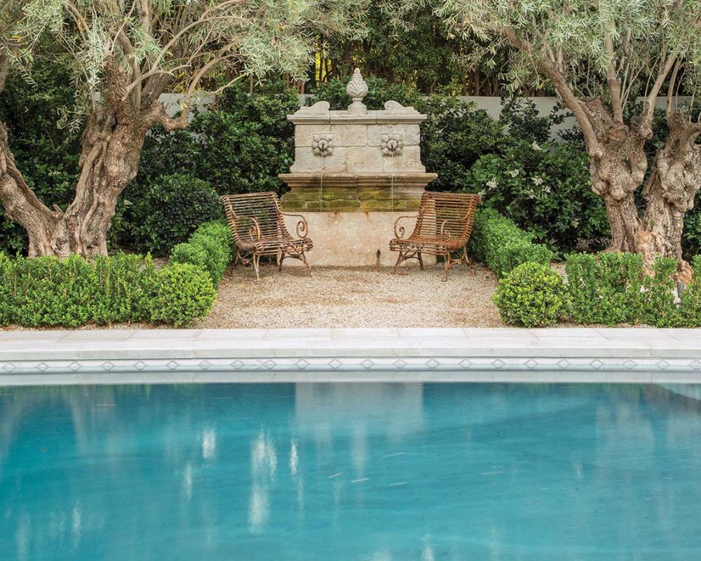 Hundred-year-old olive trees create a shady canopy, while the pool evokes what Scott Shrader calls “old school glamour.”