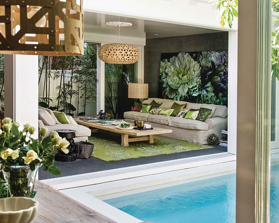 The courtyard pool abuts the living room and kitchen in the open-air home