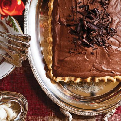 A chocolate dessert tart on a silver platter from The Art of the Host by Alex Hitz