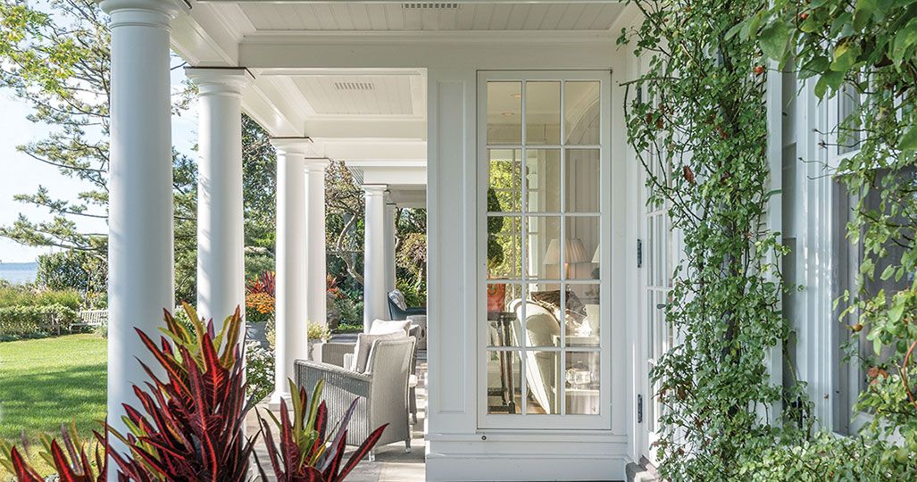 A two-level white columned porch from the pages of Renewing Tradition: The Architecture of Eric J. Smith
