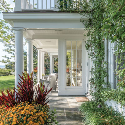 A two-level white columned porch from the pages of Renewing Tradition: The Architecture of Eric J. Smith