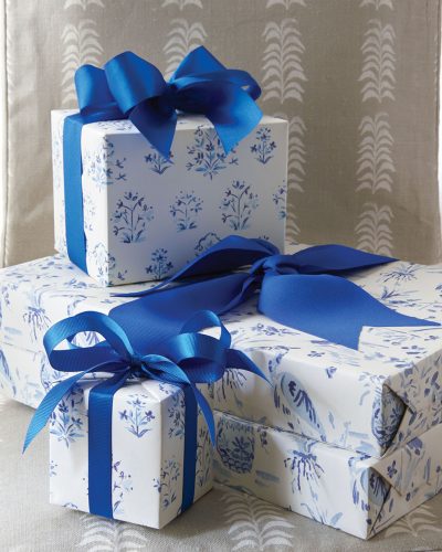 A stack of wrapped presents tied with blue ribbon