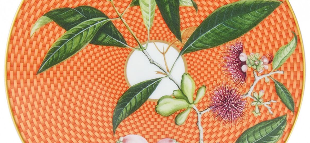 dessert plate with chrysanthemum-hued, geometric pattern behind a botanical motif