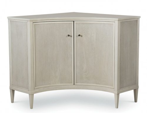 white corner cabinet with a pair of concave curved doors with a linear pattern