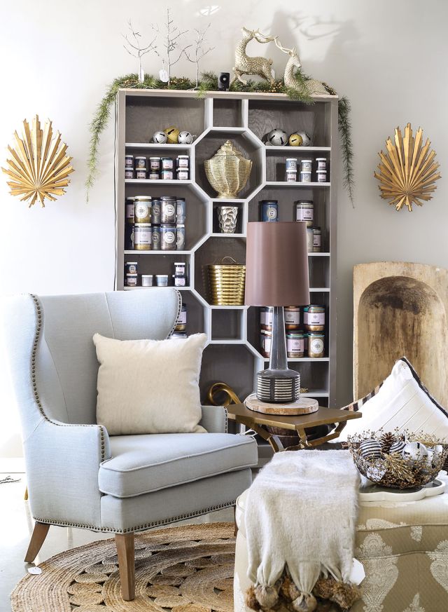 Store scene from Bridget Beari in Richmond, Virginia, includes light blue wing chair, bookcase with the shelves arranged in a geometric pattern, and other unique decor
