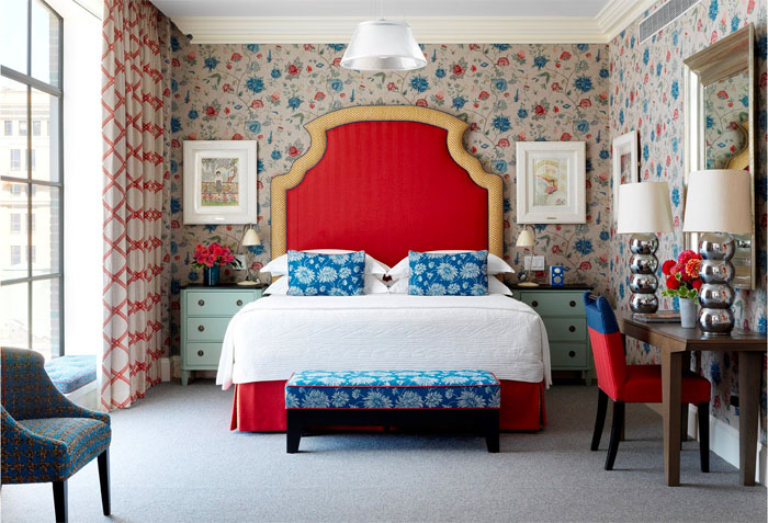 Crosby Street Hotel room with red headboard and floral wallpaper