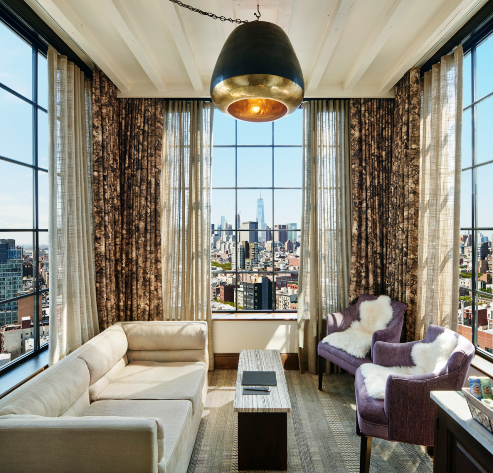 Ludlow hotel suite living area with 3-sided view of New York City skyline