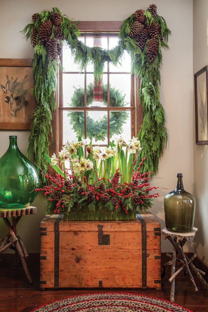 The chest sits under a natural-wood mullioned window. Using antiques and choosing such architectural details are how event planners Rick Davis and Christopher Vazquez decorates their windows for Christmas.