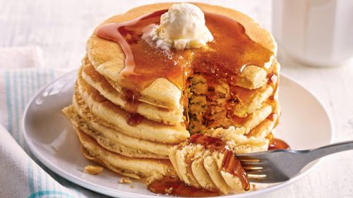 Stack of 5 pancakes with butter and syrup