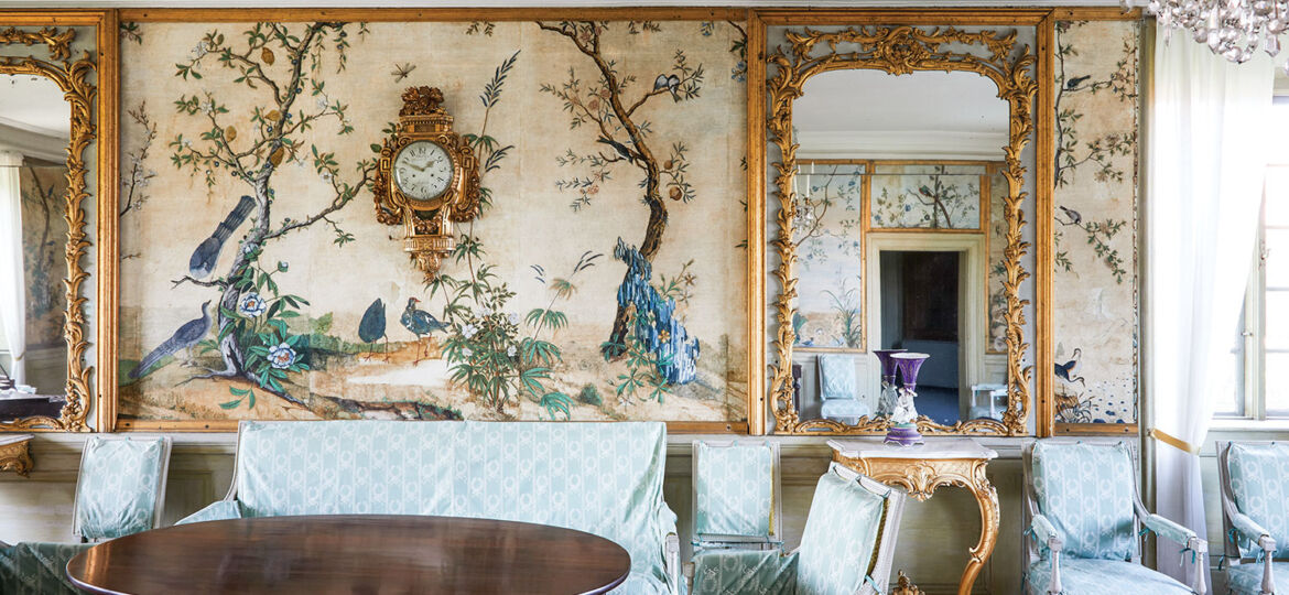 The handpainted scenic wallpaper features a landscape of peacocks and small trees.