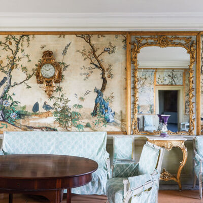 The handpainted scenic wallpaper features a landscape of peacocks and small trees.