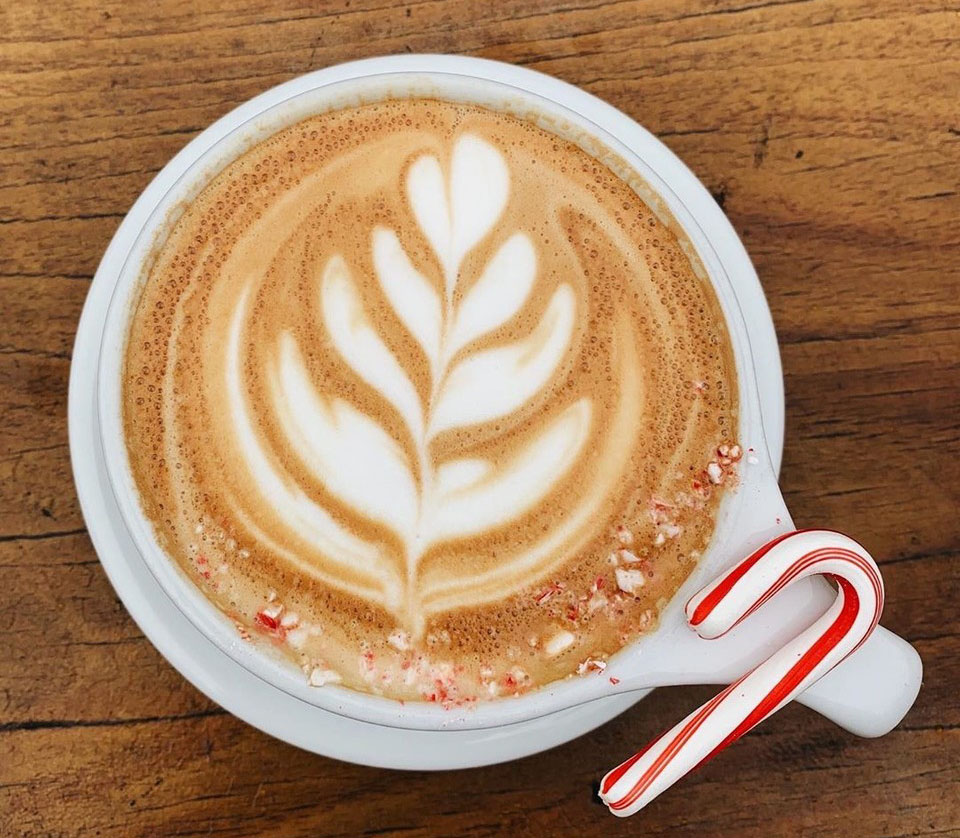 Best coffee in Asheville: Liberty House Coffee and Cafe; drink with foam in a Christmas tree design sprinkled with crushed peppermint