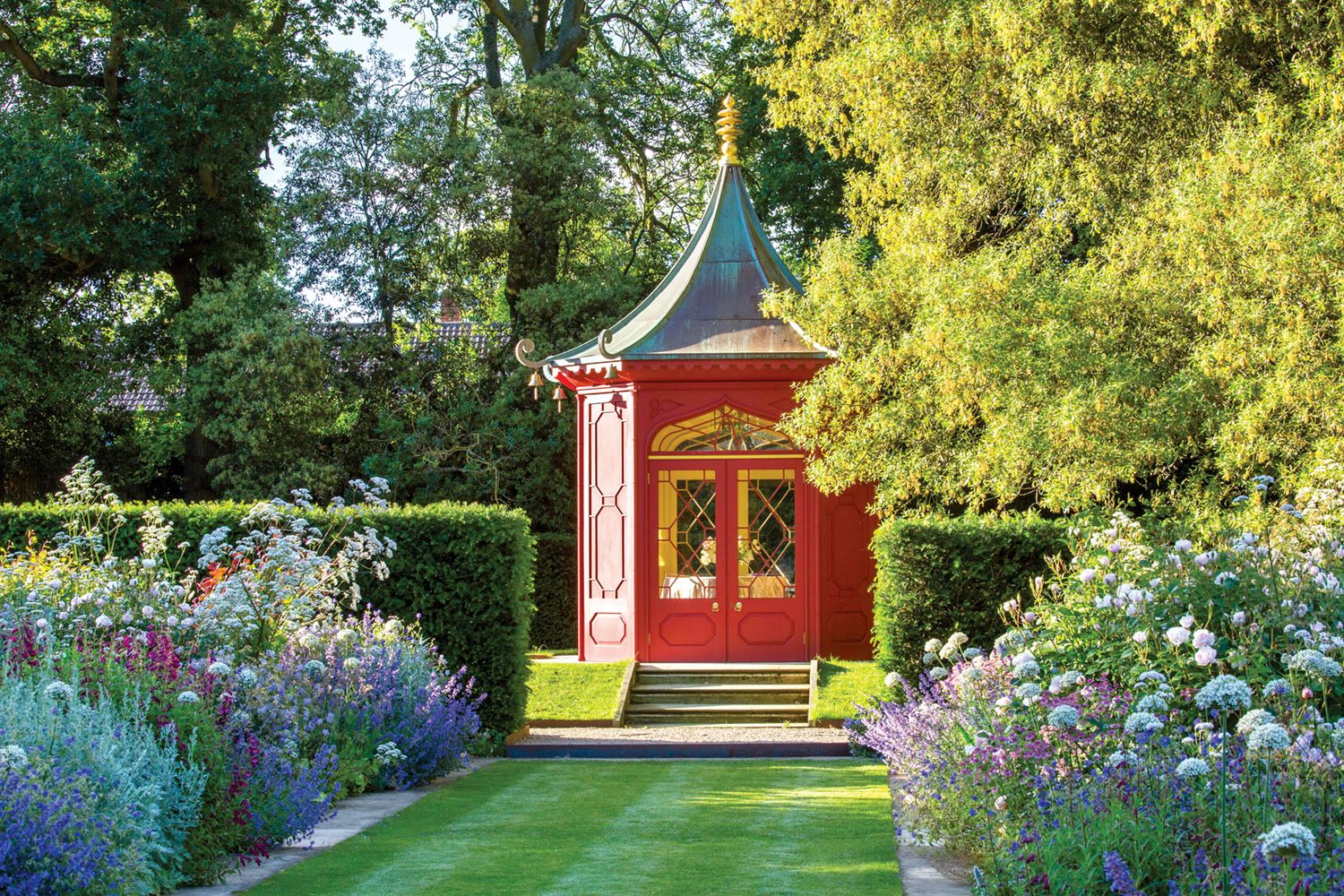 Red painted chinoiserie pavilion, double perennial borders