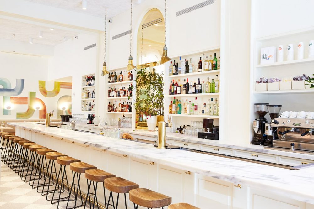 long marble bar inside Il Fiorista, a restaurant and floral boutique in New York City