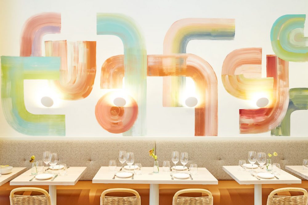 tables, chairs, banquets and abstract mural of muted colors at Il Fiorista in New York City
