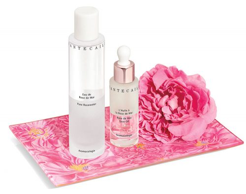 Chantecaille’s rosewater, face oil, and a bloom of the Rose de Mai sit on a rose-covered tray by artist John Derian. 