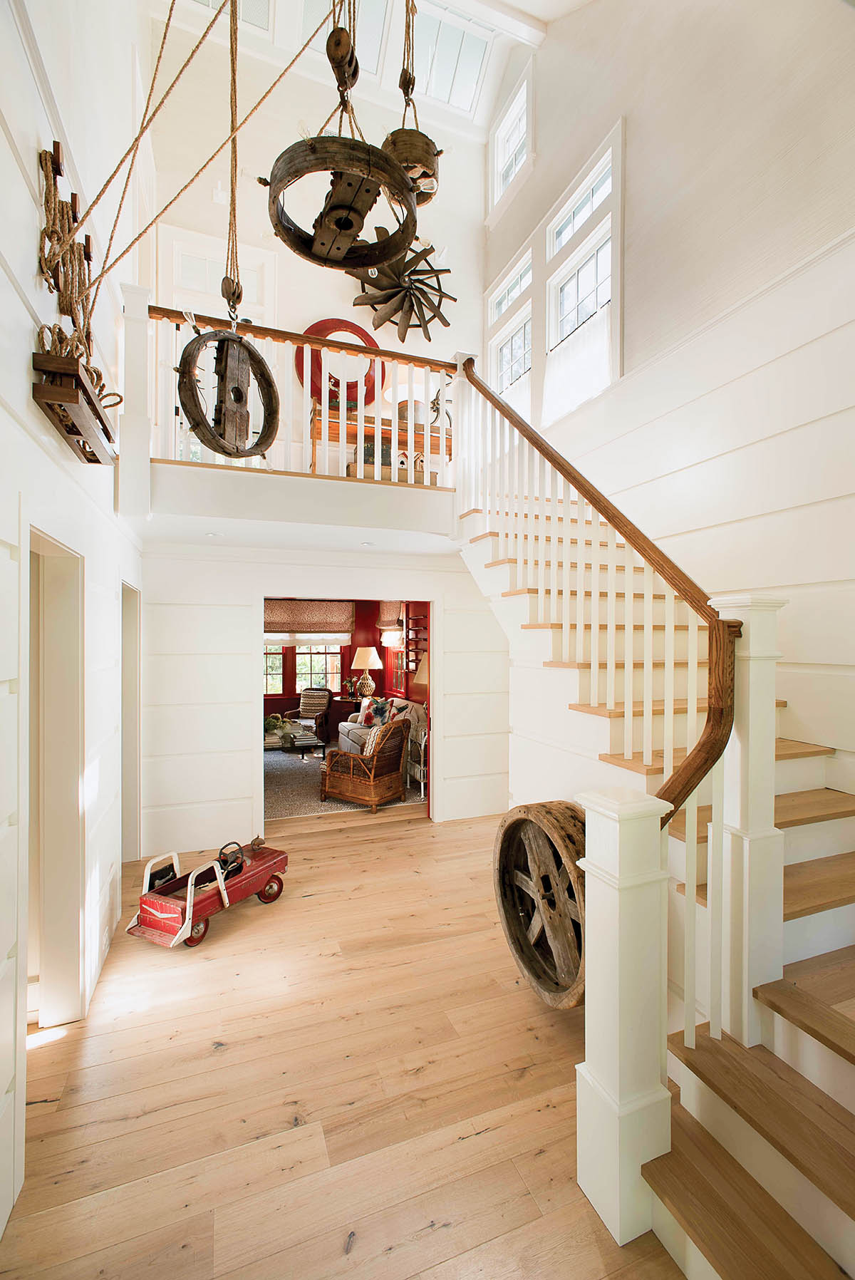 Front entry hall with elaborate light fixture made from antique farm equipment.