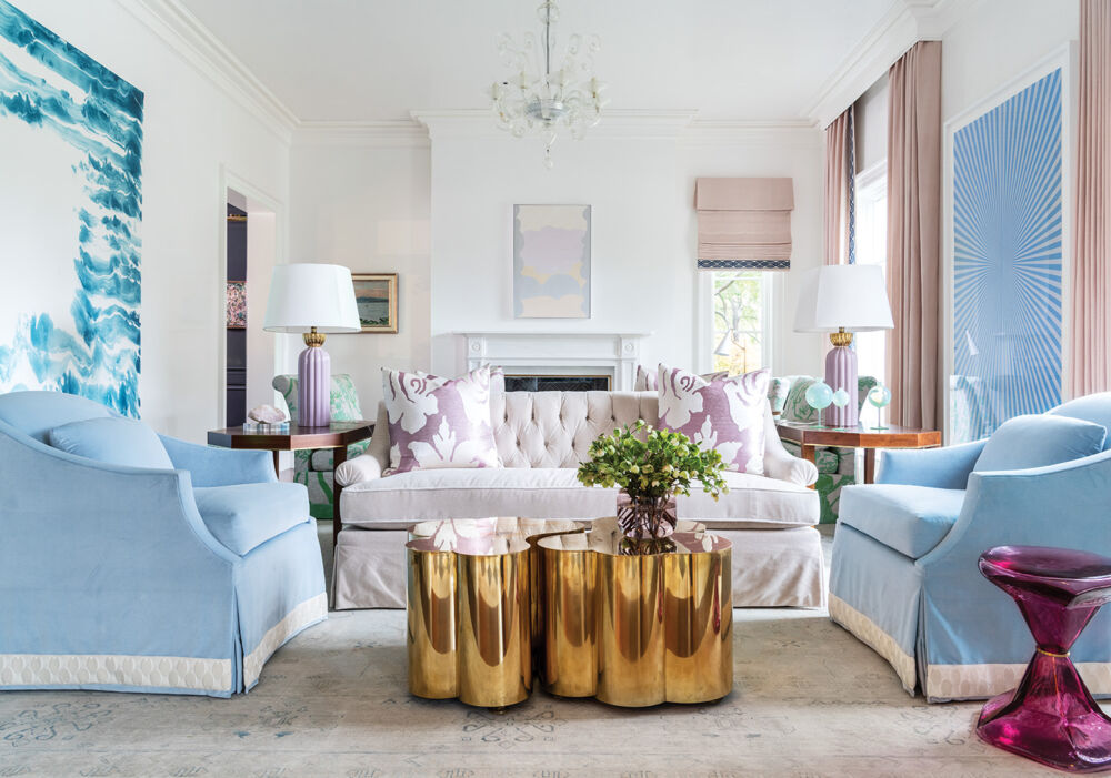 Bright pink and blue furniture make a white living room feel fun and airy.