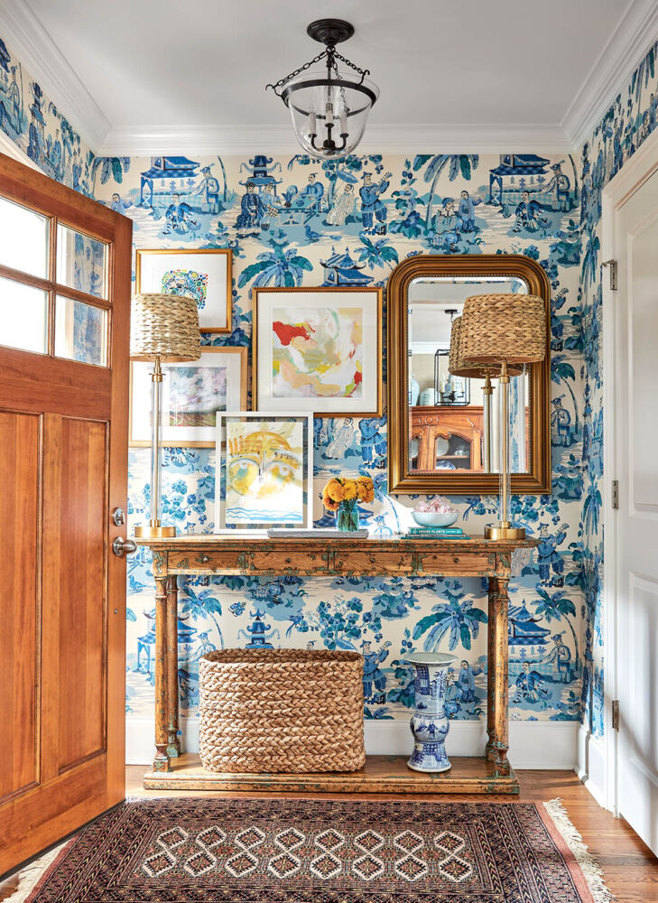 1940s cottage foyer with blue and white chinoiserie wallpaper. Interior design by Maggie Griffin.