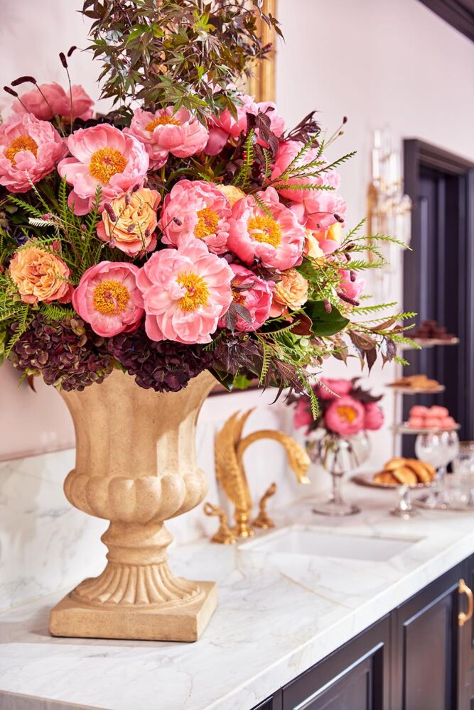 Arrangement of peonies, roses, hydrangeas, and Japanese maple branches designed by Kirk Whitfield on morning bar in the Flower Atlanta showhouse