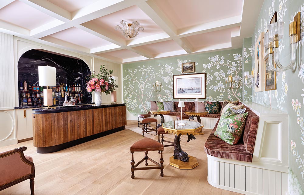 Secret speakeasy on the terrace level of the Flower Atlanta Showhouse. Large banquette with three tables in right corner of the room, black marble-topped bar on the left.