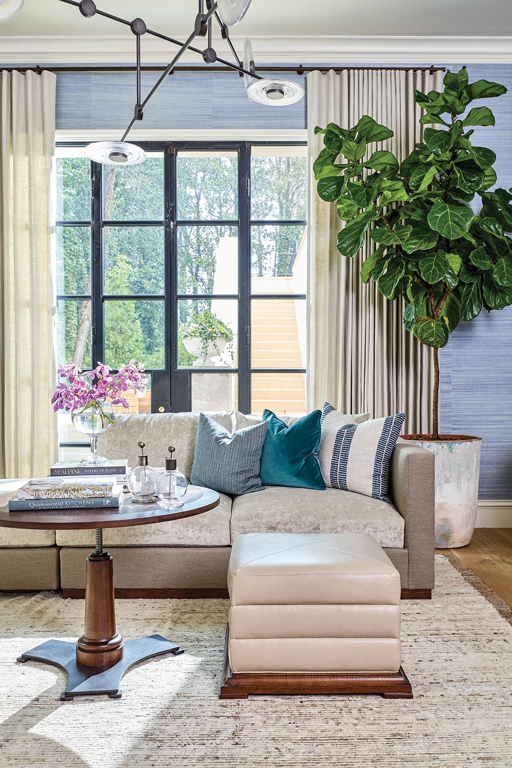 Sectional sofa, ottoman, and round table in Ray Booth designed family room of the the Flower Atlanta Showhouse