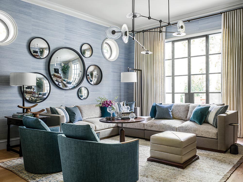 Ray Booth designed family room with round mirrors on wall, mobile chandelier, and sectional sofa at the Flower Atlanta Showhouse