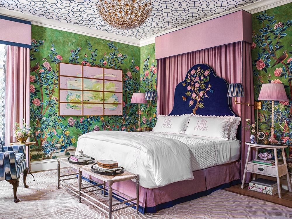 A Thibaut wallpaper mural, profuse with blooms, birds, and butterflies, envelops the room. Trellis wallpaper on the ceiling. Designer Lisa Mende also used a radiating carpet design from The Rug Company.