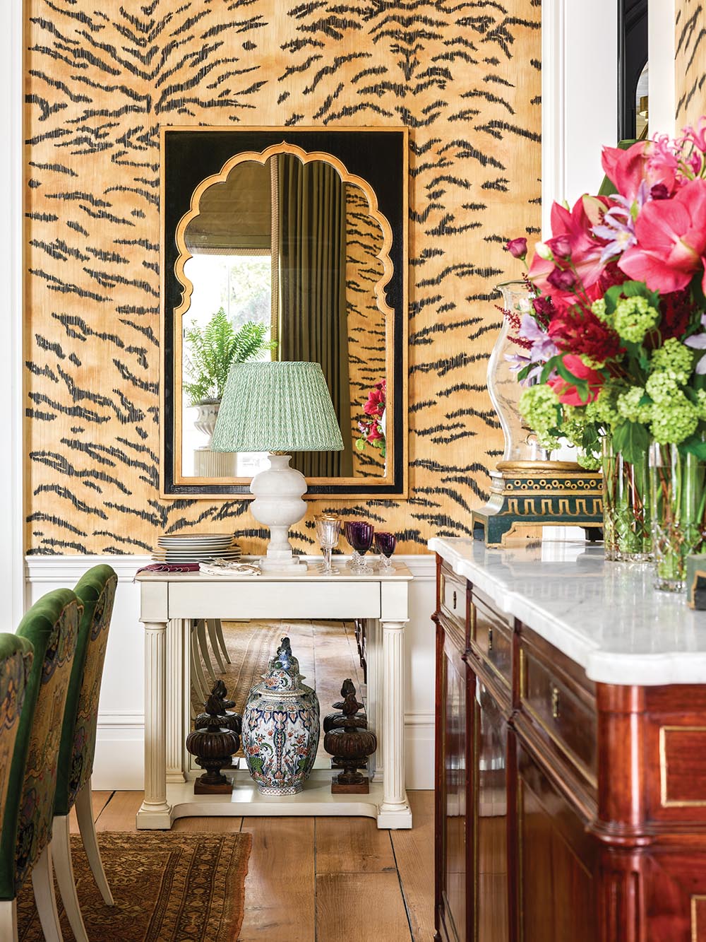Sideboard and console in tiger-wallpapered dining room designed by Alexa Hampton.
